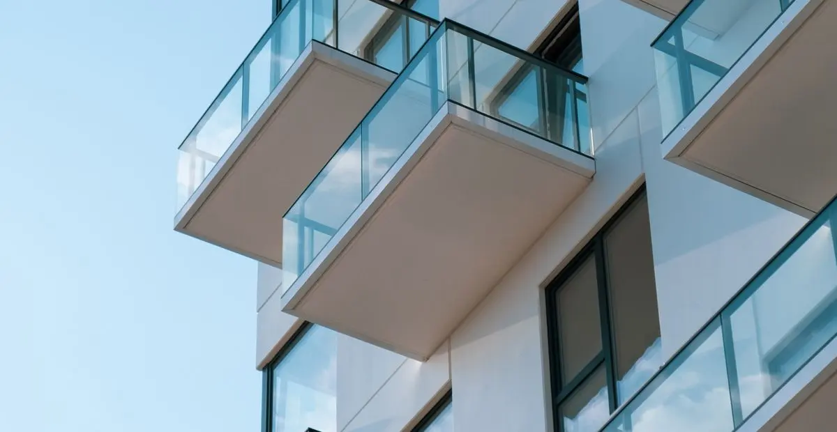 Glass balconies of a modern apartment building, illustrative